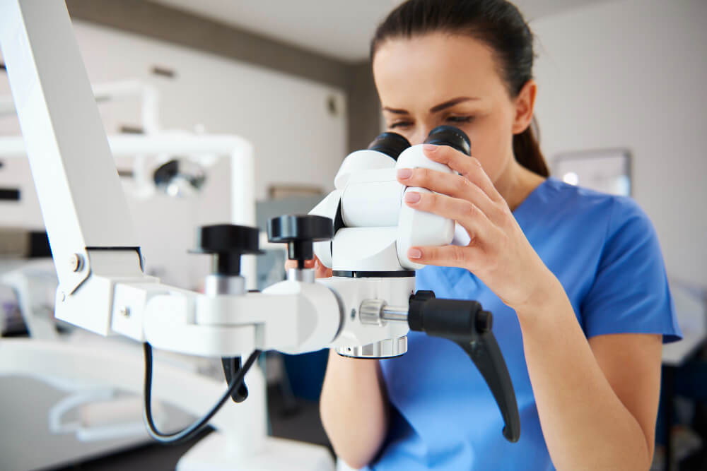 close-up-female-dentist-looking-through-dental-microscope (1)