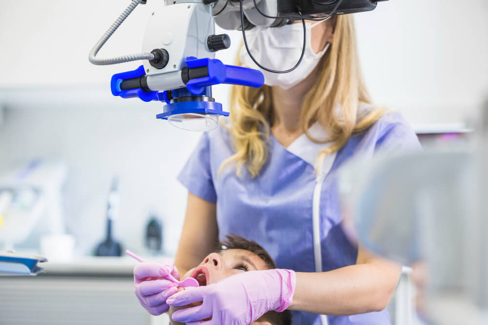 dentist-examining-patient-s-teeth-through-microscope-clinic (1)